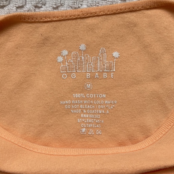 Pastel orange, crop top, with hole out for cleavage. - Picture 3 of 3